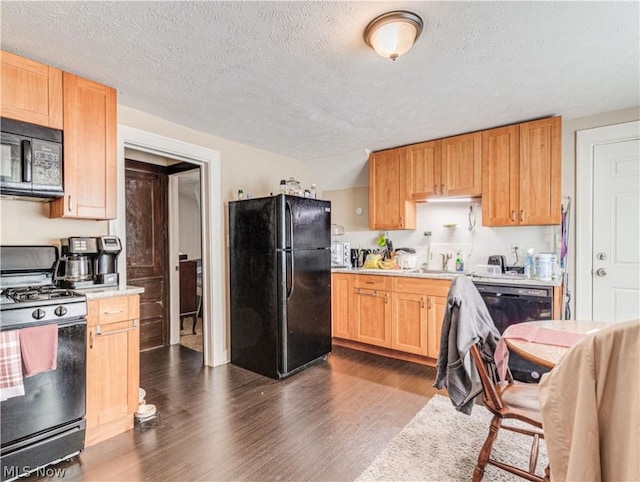 5521 W 48th St, Parma, OH 44134 - kitchen featuring black appliances, light countertops, dark wood-type flooring, and a textured ceiling