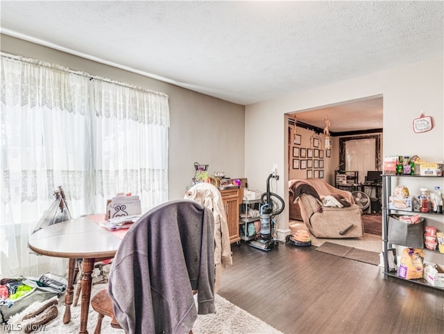 dining area with a textured ceiling and hardwood / wood-style floors