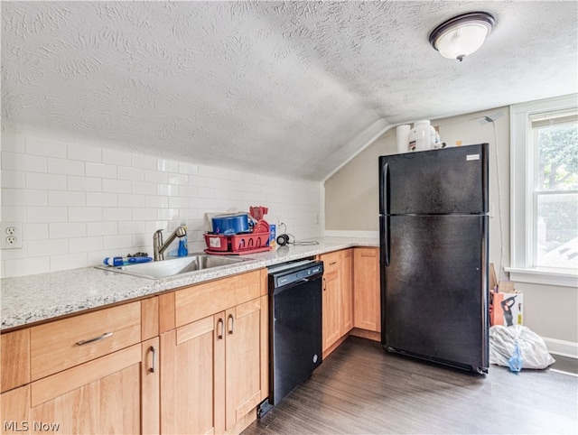 kitchen featuring dark wood-type flooring, a textured ceiling, black appliances, and vaulted ceiling