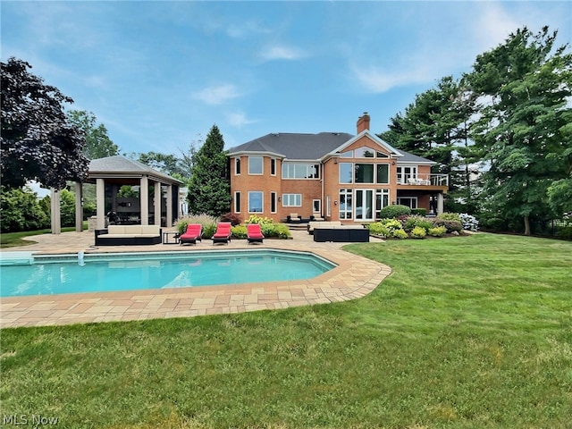 back of house featuring a gazebo, an outdoor living space, a yard, and a patio