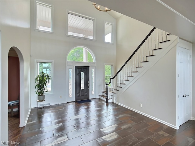 foyer entrance with a towering ceiling