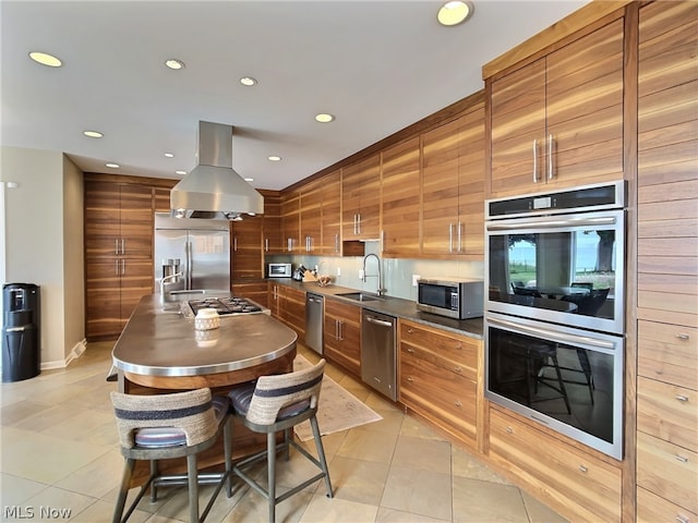 kitchen featuring light tile patterned flooring, a kitchen island, island range hood, sink, and stainless steel appliances