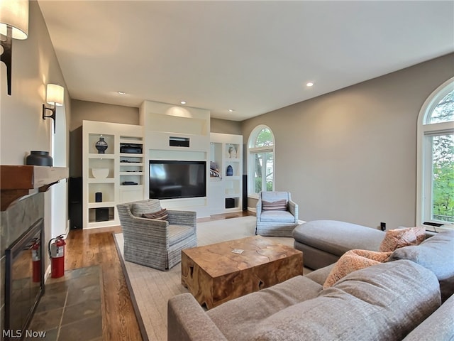 living room with a healthy amount of sunlight and hardwood / wood-style floors