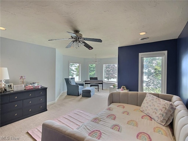 bedroom featuring light carpet and ceiling fan with notable chandelier