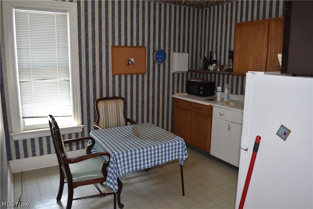 kitchen with white fridge and light tile patterned floors