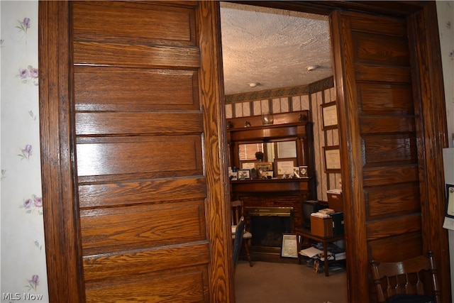 room details featuring a textured ceiling and a brick fireplace