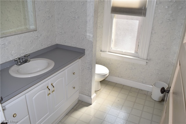 bathroom with vanity, tile patterned flooring, and toilet