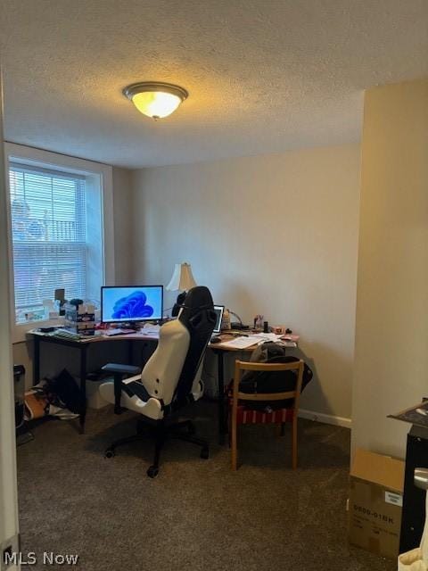 home office featuring carpet flooring and a textured ceiling