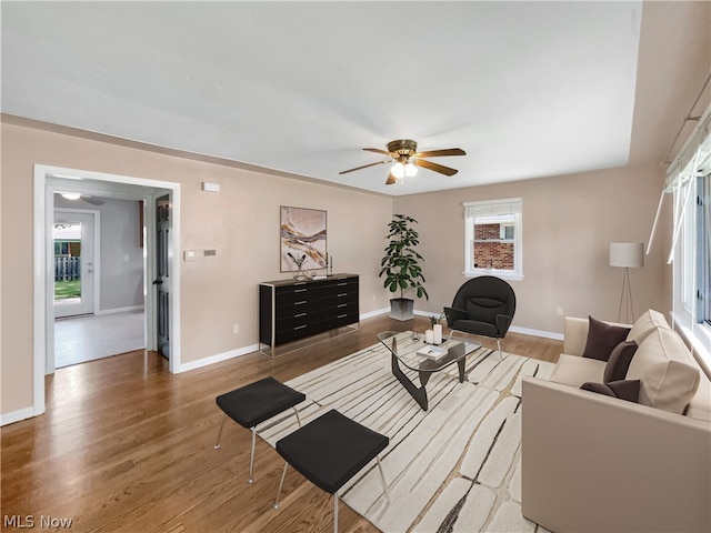 living room featuring wood-type flooring and ceiling fan