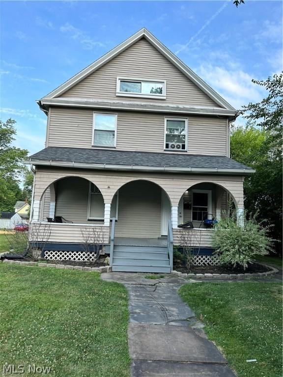 view of front of house featuring a front yard and covered porch