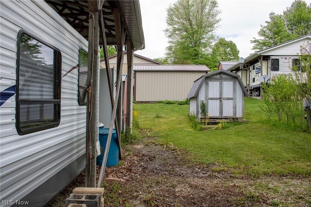 view of yard with a storage unit and an outbuilding