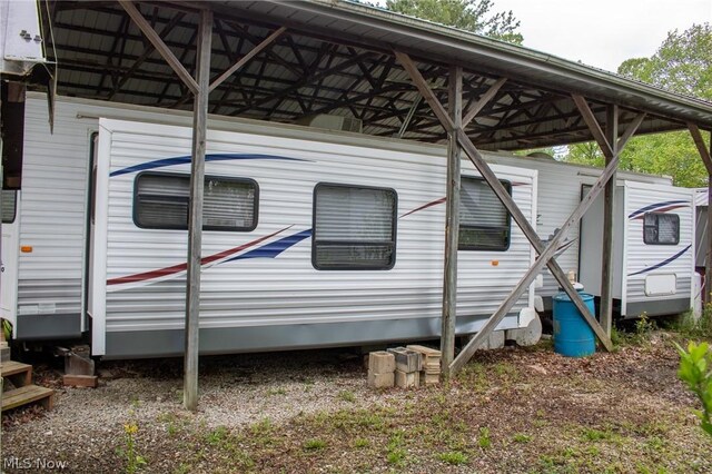 view of side of home featuring a detached carport