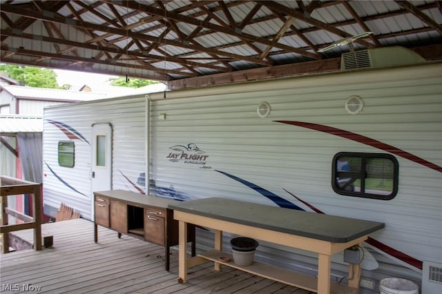 wooden deck featuring visible vents