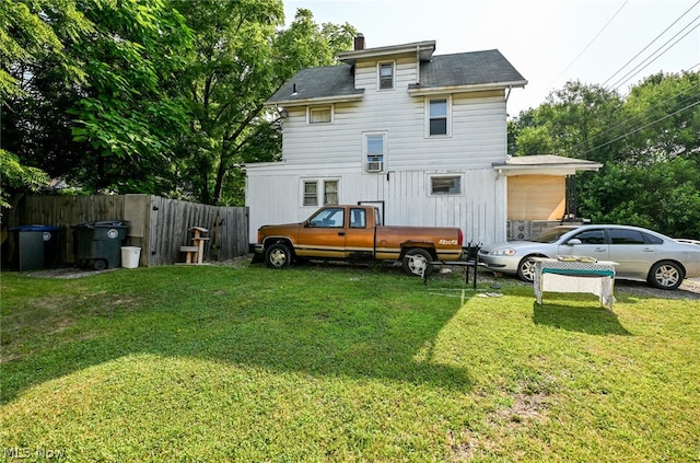 back of house featuring a yard