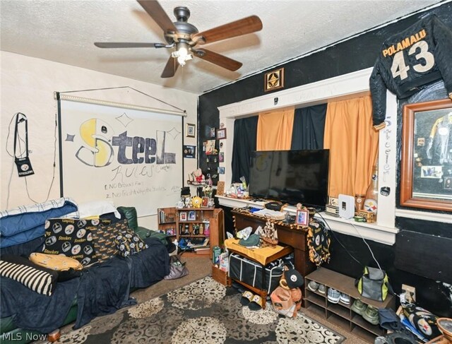 living room with ceiling fan and a textured ceiling