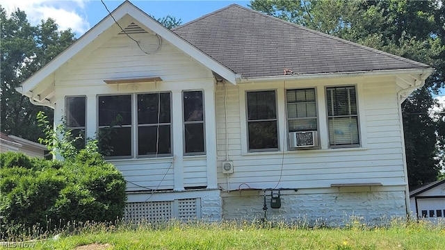 view of home's exterior featuring roof with shingles