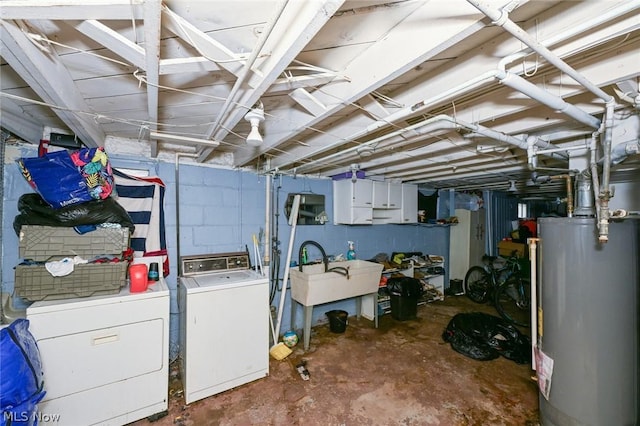 unfinished below grade area with washer and clothes dryer, gas water heater, and a sink