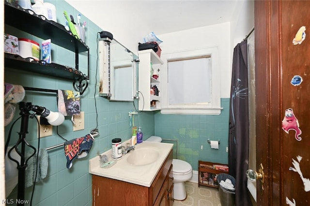 full bathroom with toilet, a shower with shower curtain, tile walls, and vanity