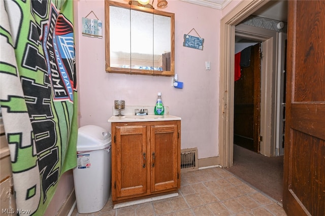 bathroom featuring vanity and ornamental molding