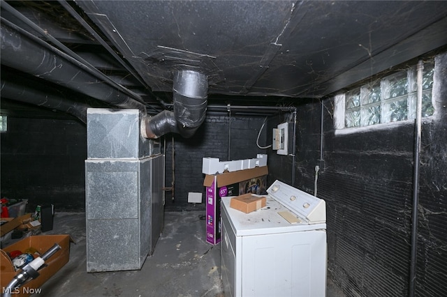 basement featuring washer / dryer, electric panel, and heating unit