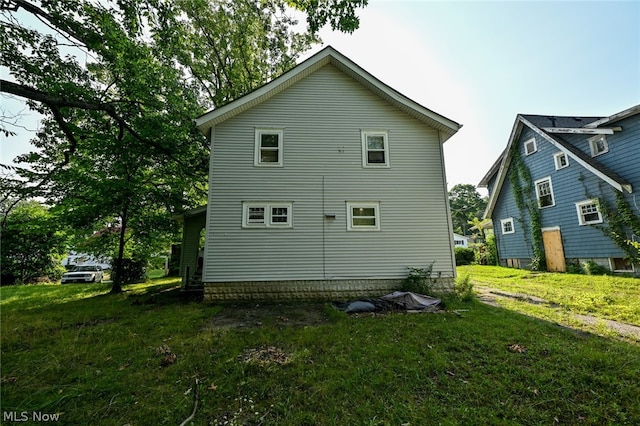 view of property exterior featuring a lawn