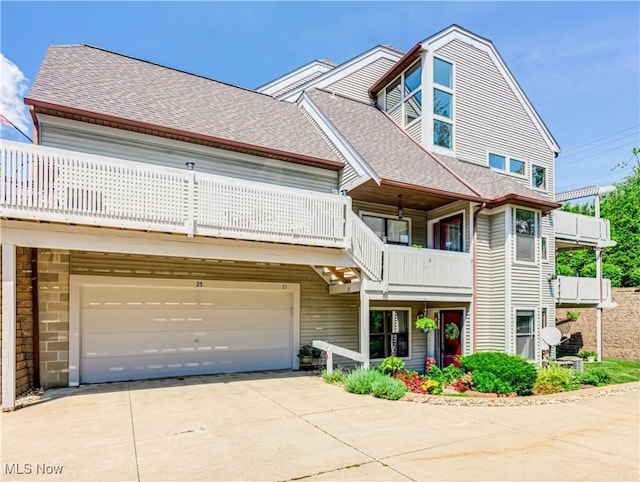 view of front of property featuring a balcony and a garage