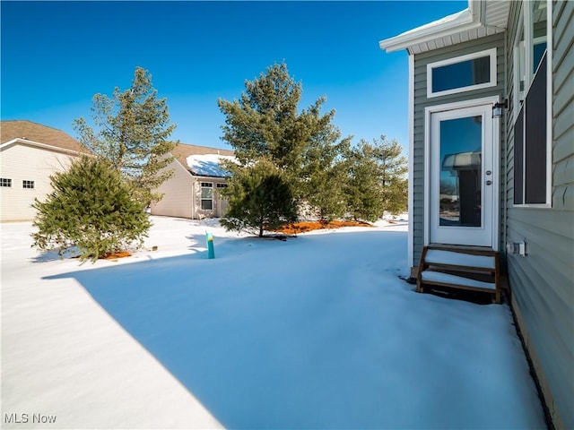 snowy yard featuring an outbuilding