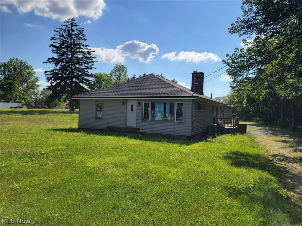 back of property featuring a lawn