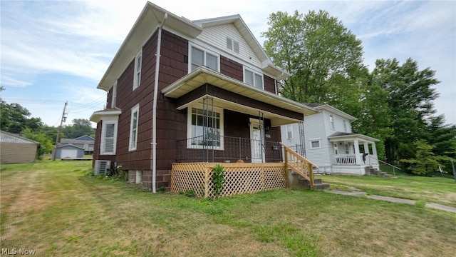 view of front of house with a front yard and a porch