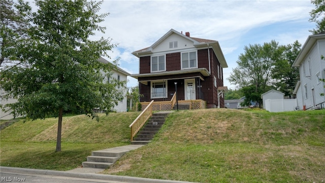 view of front of property featuring a porch and a front lawn