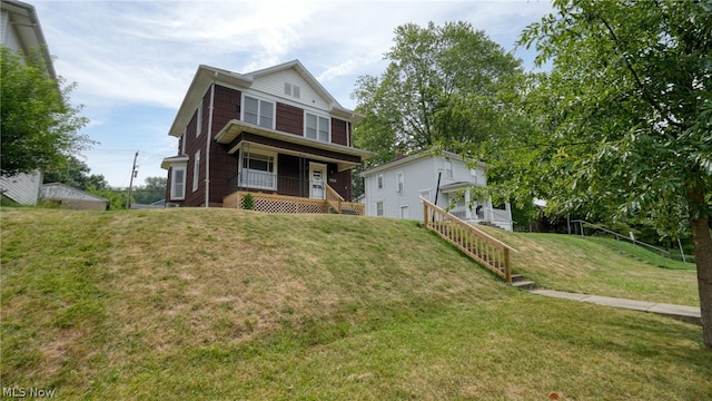 view of front of house featuring covered porch and a front lawn