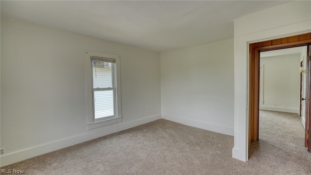 spare room with light colored carpet