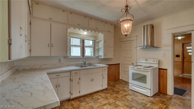 kitchen with decorative light fixtures, sink, white cabinetry, electric range, and wall chimney range hood