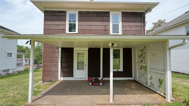 entrance to property featuring a lawn