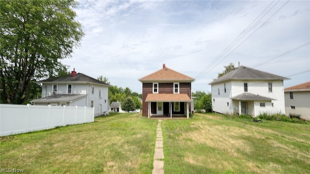 rear view of house with a lawn