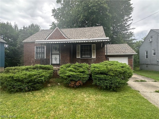 view of front of property with a front yard and a garage