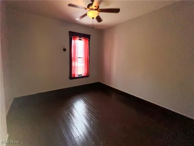 spare room with wood-type flooring and ceiling fan