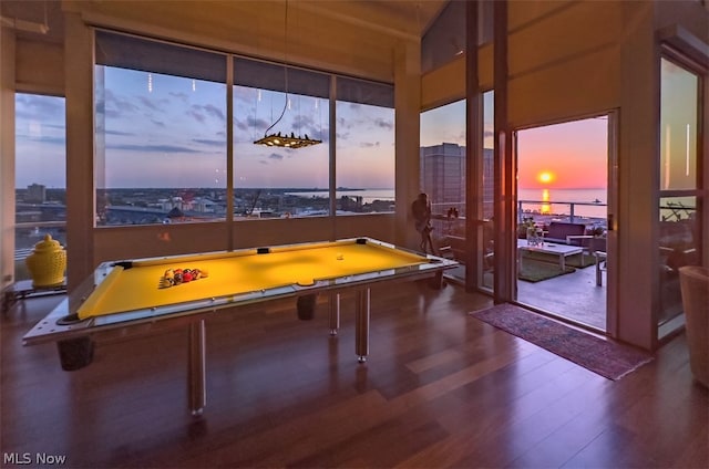 recreation room with a water view, hardwood / wood-style flooring, plenty of natural light, and billiards