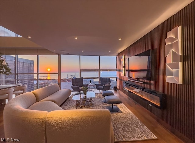 living room with wood-type flooring and floor to ceiling windows