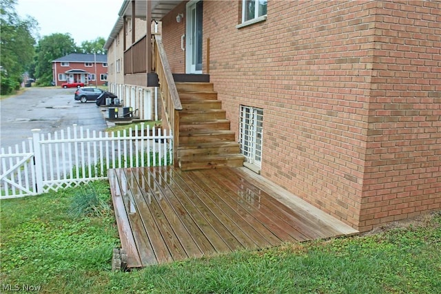 view of property exterior with fence and brick siding