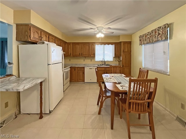 kitchen featuring sink, ceiling fan, white appliances, and light tile patterned floors