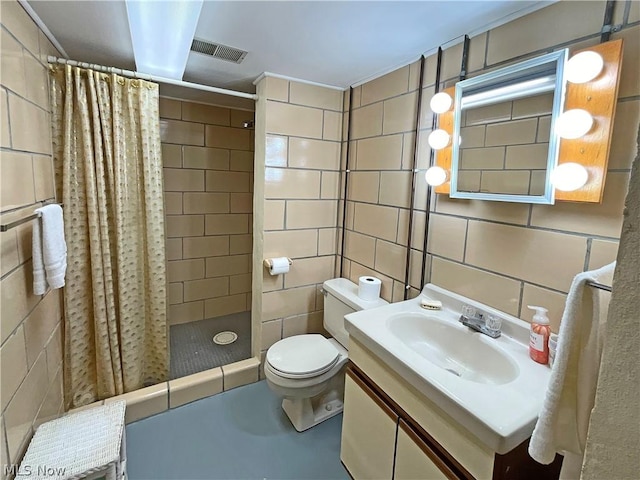 full bathroom with visible vents, toilet, vanity, a shower stall, and tile walls