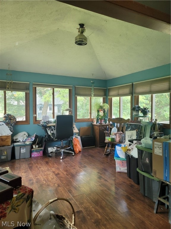 office featuring vaulted ceiling, a textured ceiling, and hardwood / wood-style floors