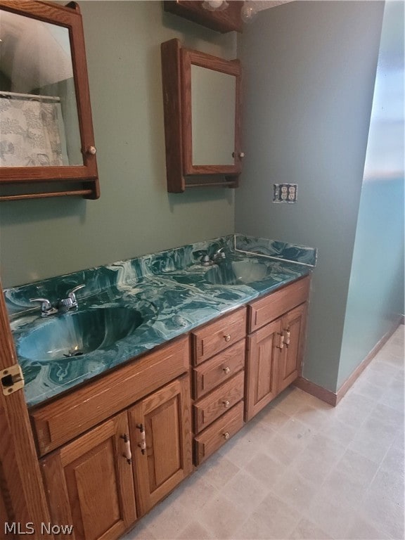 bathroom featuring tile patterned floors and dual bowl vanity