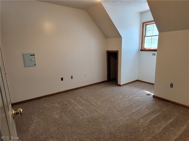 bonus room featuring light carpet and vaulted ceiling