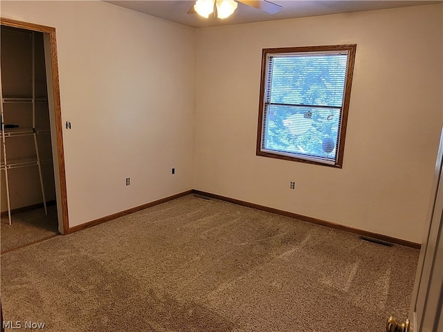 unfurnished bedroom featuring a closet, carpet floors, and ceiling fan