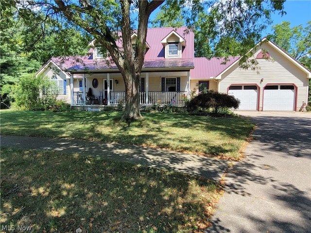 view of front of house featuring a garage, a porch, and a front yard