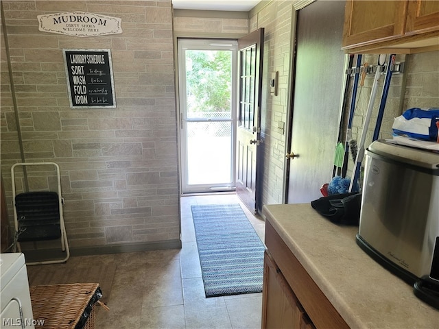 doorway to outside featuring light tile patterned flooring