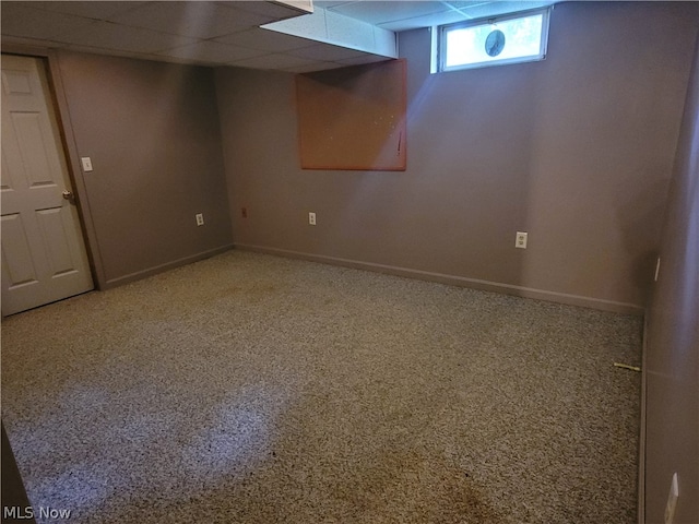 basement featuring carpet and a drop ceiling