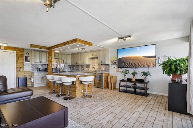 living room featuring sink and light hardwood / wood-style floors